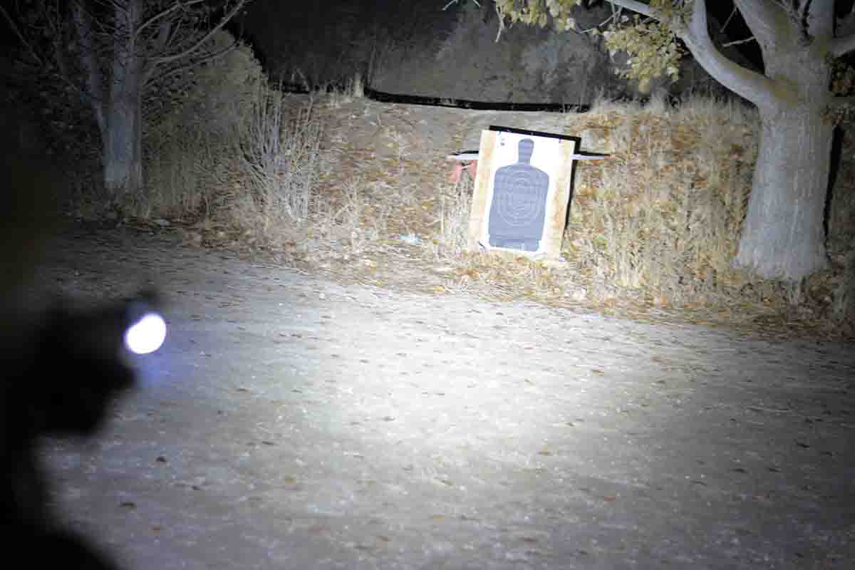 If this were a real intruder, he would be in trouble. This photo was taken in virtually total darkness; the target is the standard NRA B-27 (by Kleen Bore) at 25 yards distance and is illuminated by the Streamlight TLR-1 HL light with 1000 lumens.